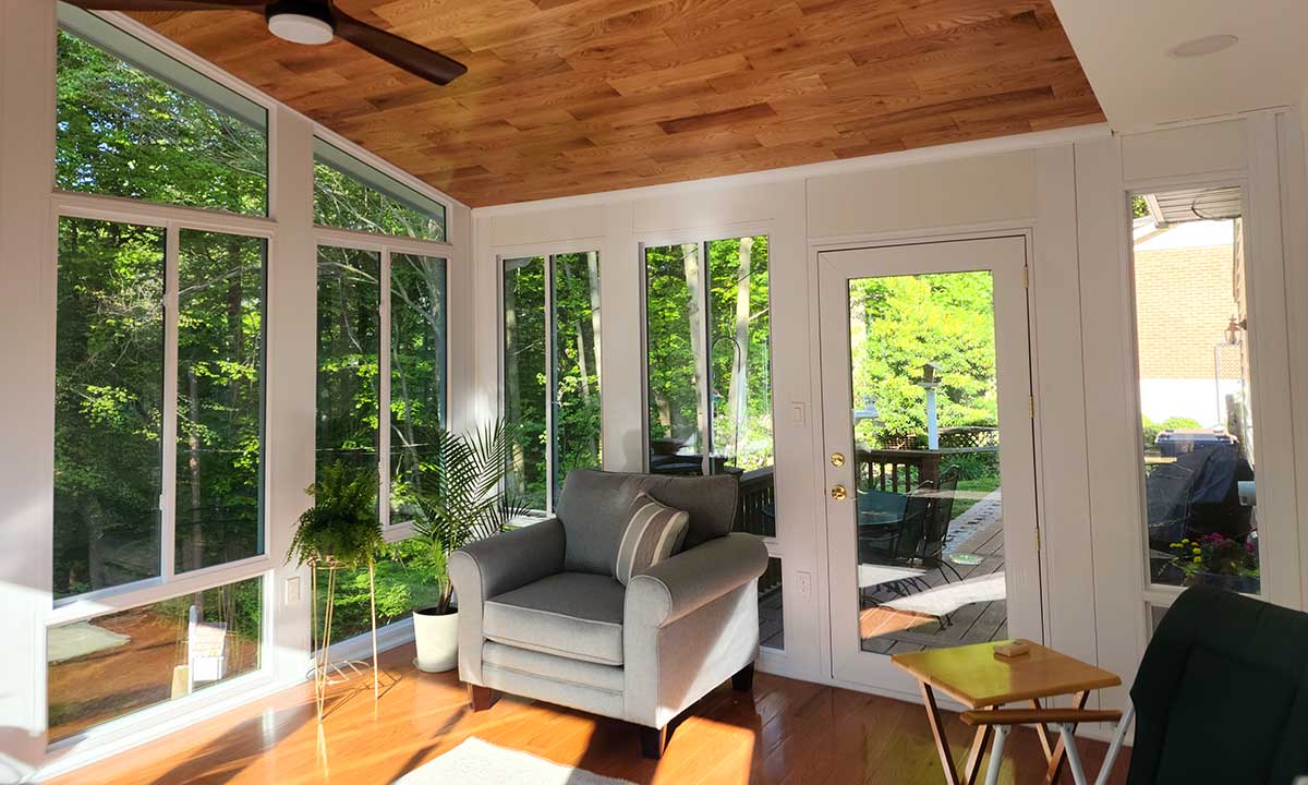 Sunroom with ceiling fan and wooden ceiling