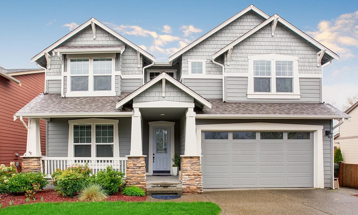 Large home with garage, and big driveway.