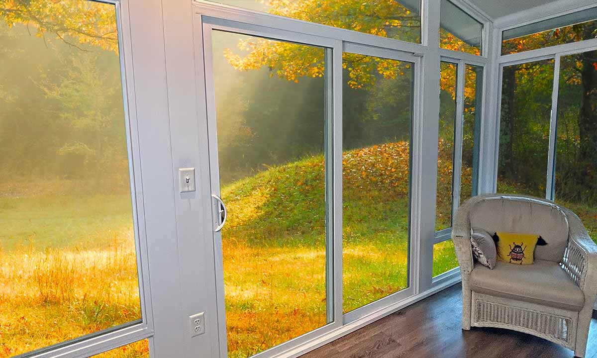 Patio door on sunroom with view of nature