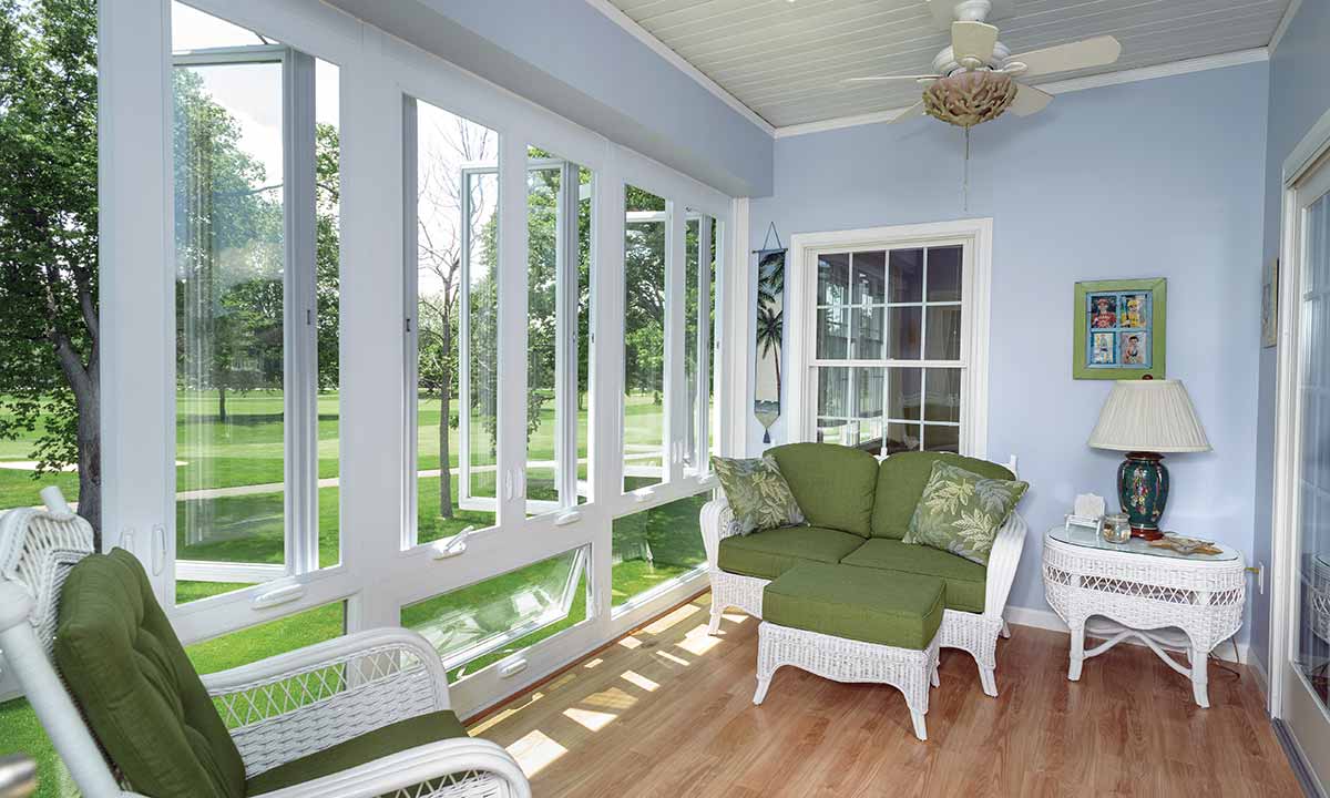 Sunroom with furniture and windows