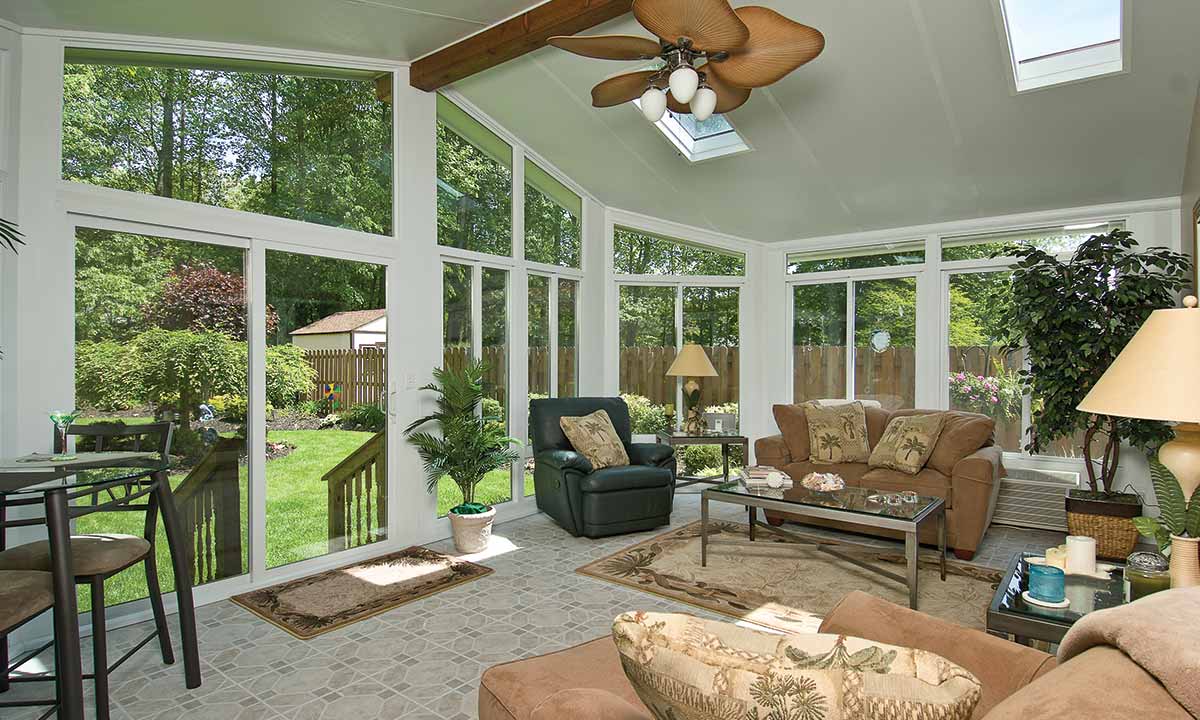 Sunroom with ceiling fan and skylight