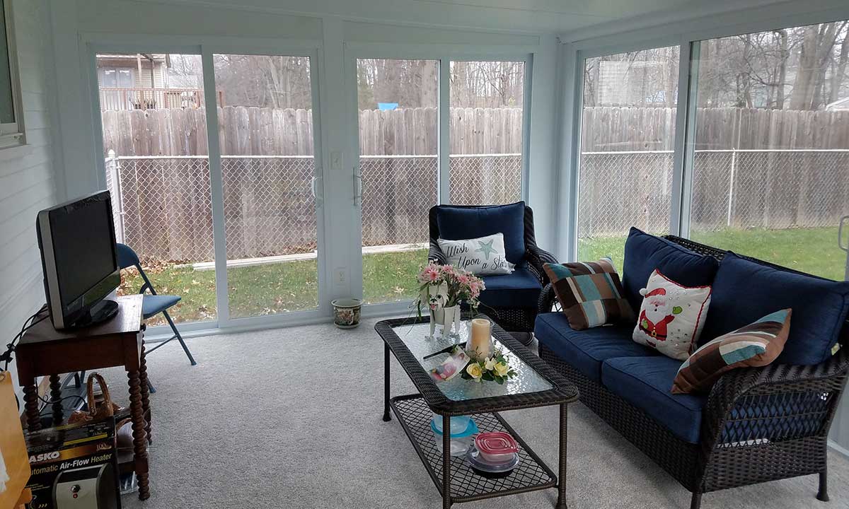 Sunroom with blue couch and coffee table