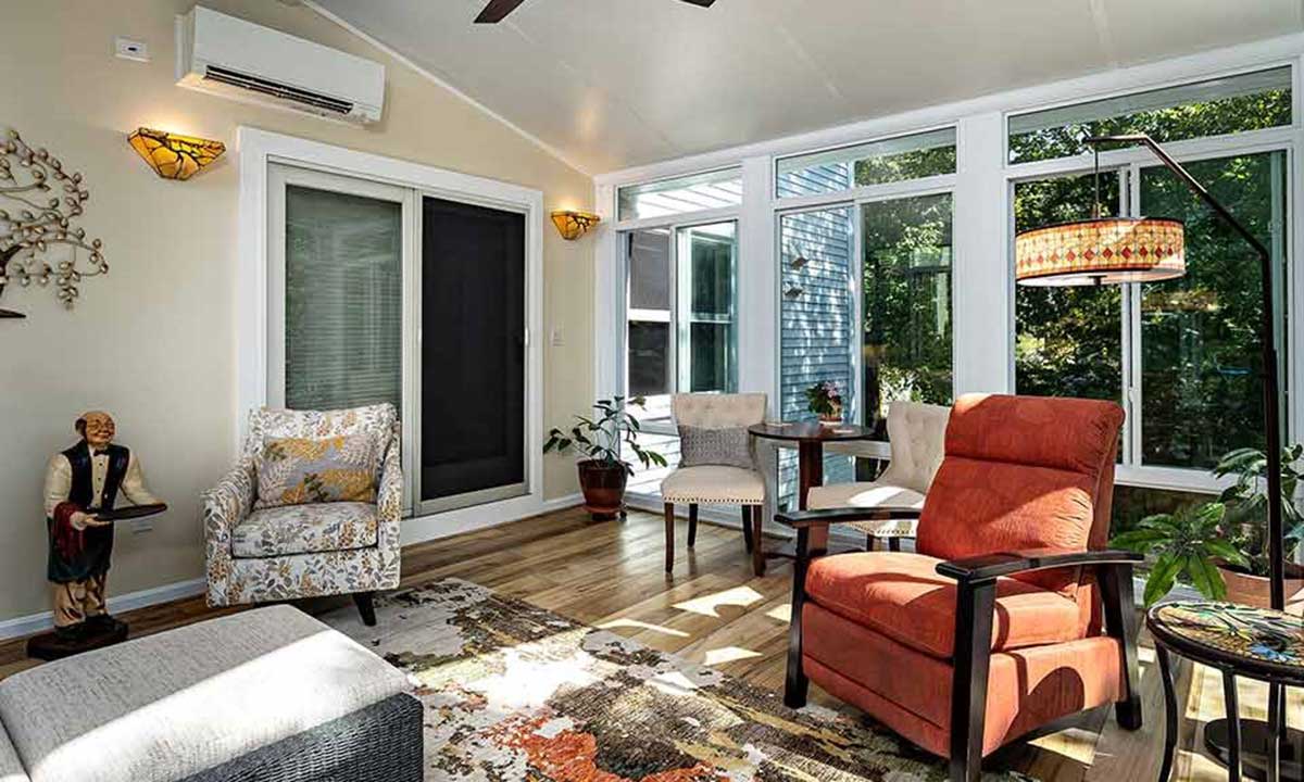 Sunroom with furniture and patio door