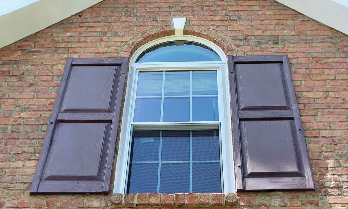 arched windows on home with shutters