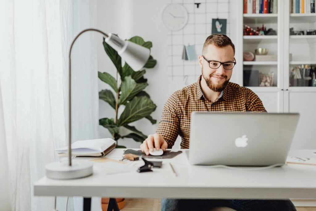 customer smiling while using computer to shop online