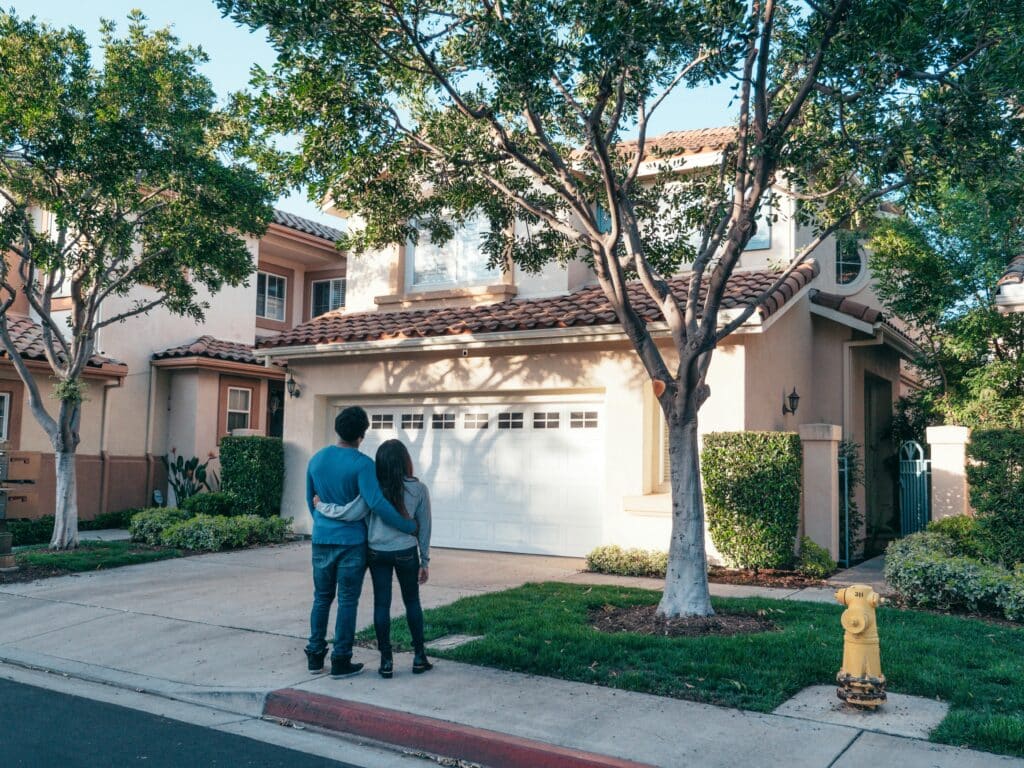 Couple standing outside their home