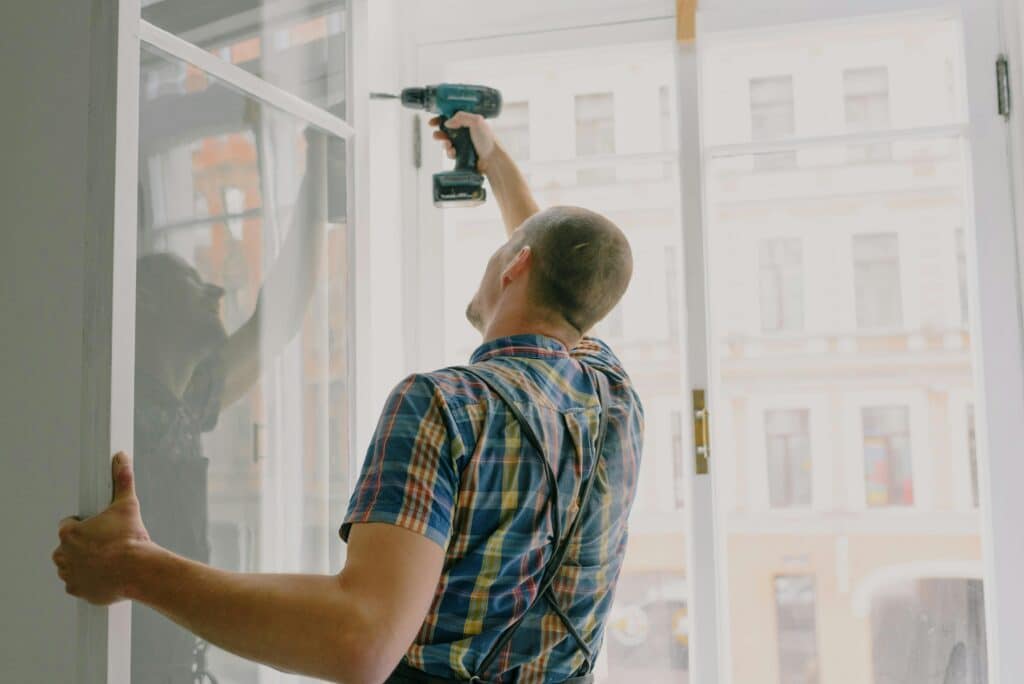 Man using screwdriver to install windows